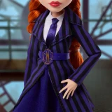 Monster High Agnes DeMille Monster High Wednesday Series 10 Inch Doll, close-up of doll dressed in a purple and black striped blazer and skirt, with white shirt and purple tie, featuring red hair in pigtails and a detailed belt with an N emblem.
