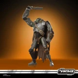 Star Wars Mercenary Droid Star Wars Vintage Collection 3.75-Inch Action Figure VC407, detailed action figure of a rugged droid in a dramatic pose with a cape and gear, on a warm brown background.