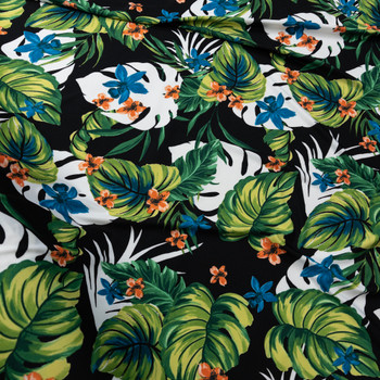 Green, Orange, Teal, and White Tropical Floral on Black Poly/Spandex Knit Fabric By The Yard - Wide shot