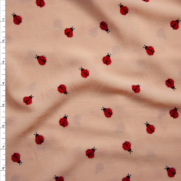 Ladybugs on Peach Bubble Crepe Fabric By The Yard