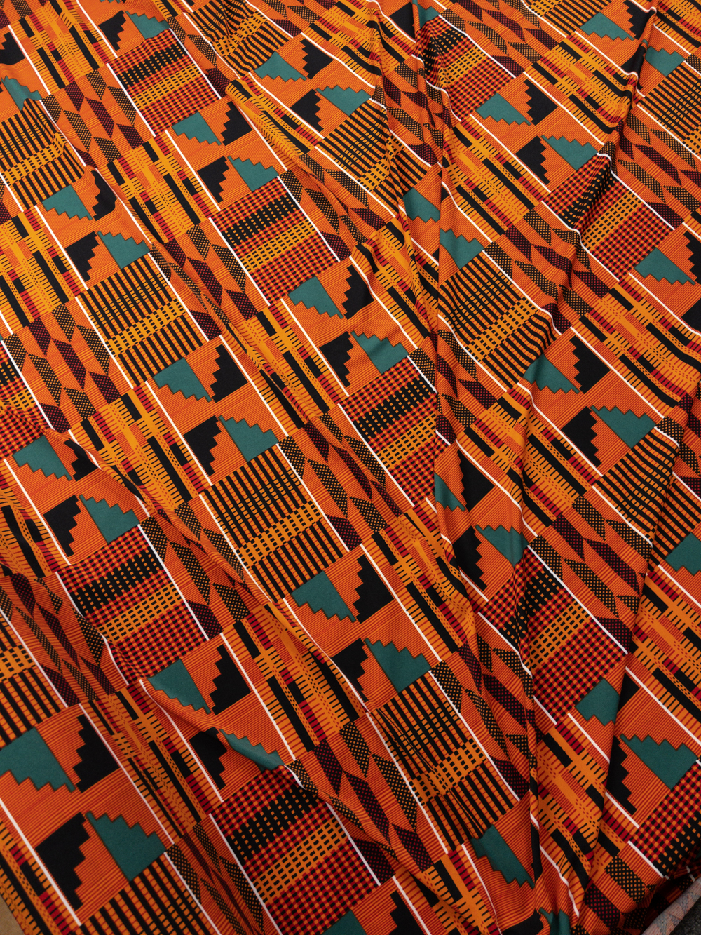 Orange, Black, and Green African Print Stretch Designer ITY Knit Fabric By The Yard - Wide shot