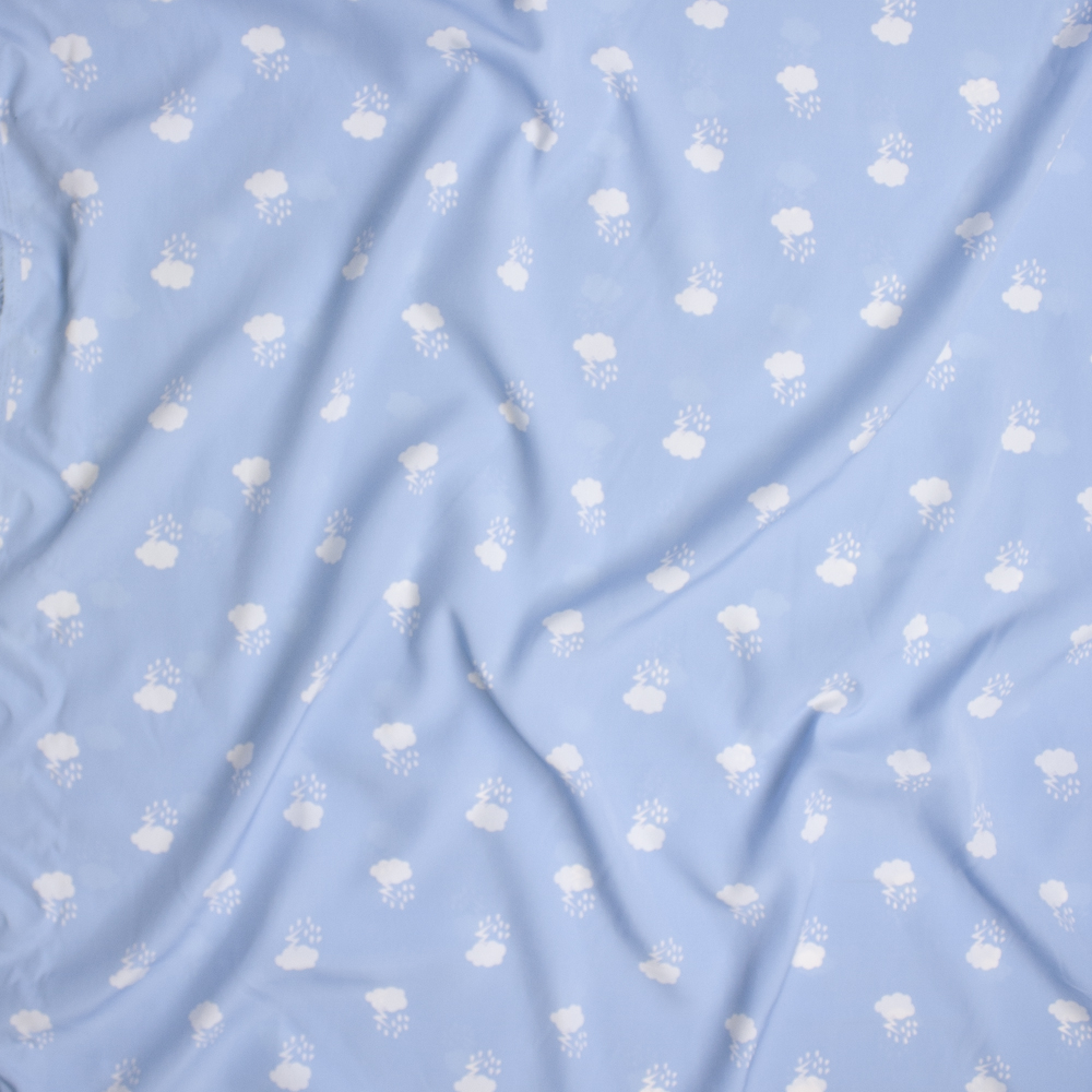 White Thunderclouds on Baby Blue Poly Peachskin Fabric By The Yard - Wide shot