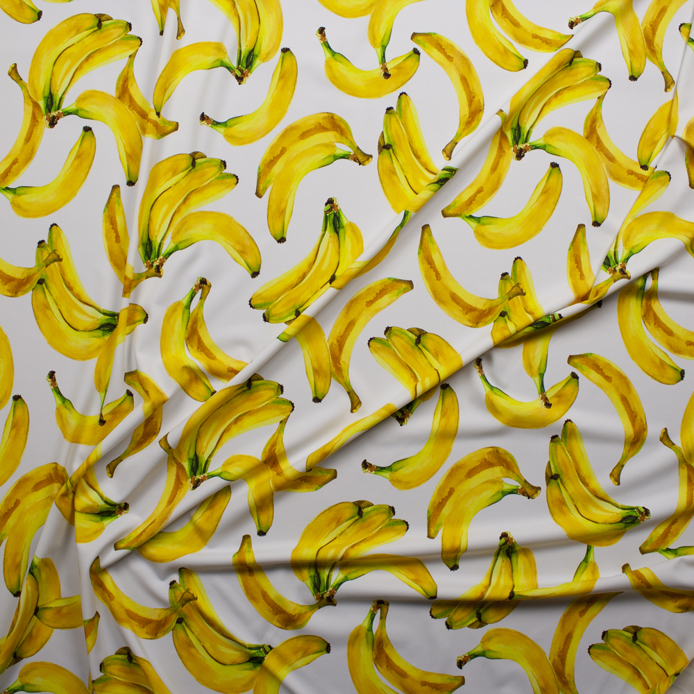 Tossed Bananas on White Premium 5.8oz Nylon/Spandex Fabric By The Yard - Wide shot