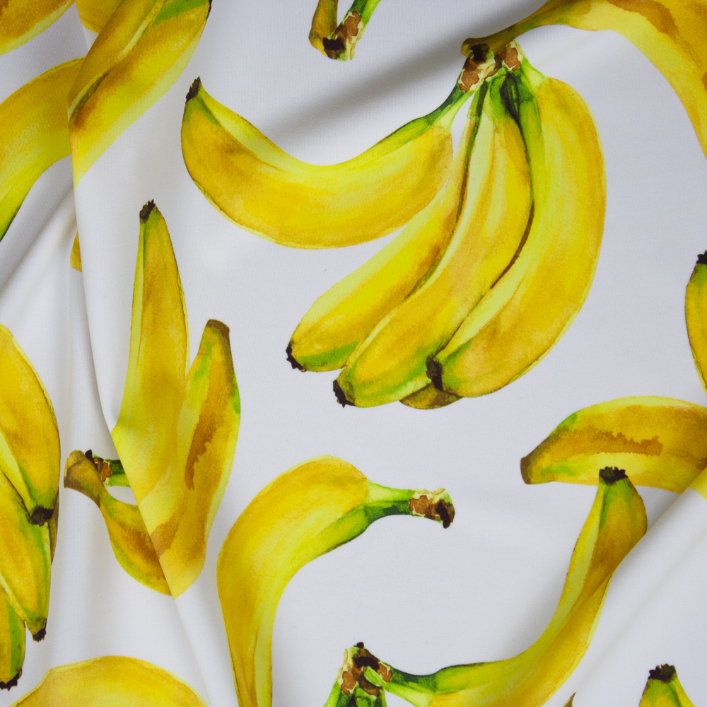 Tossed Bananas on White Premium 5.8oz Nylon/Spandex Fabric By The Yard
