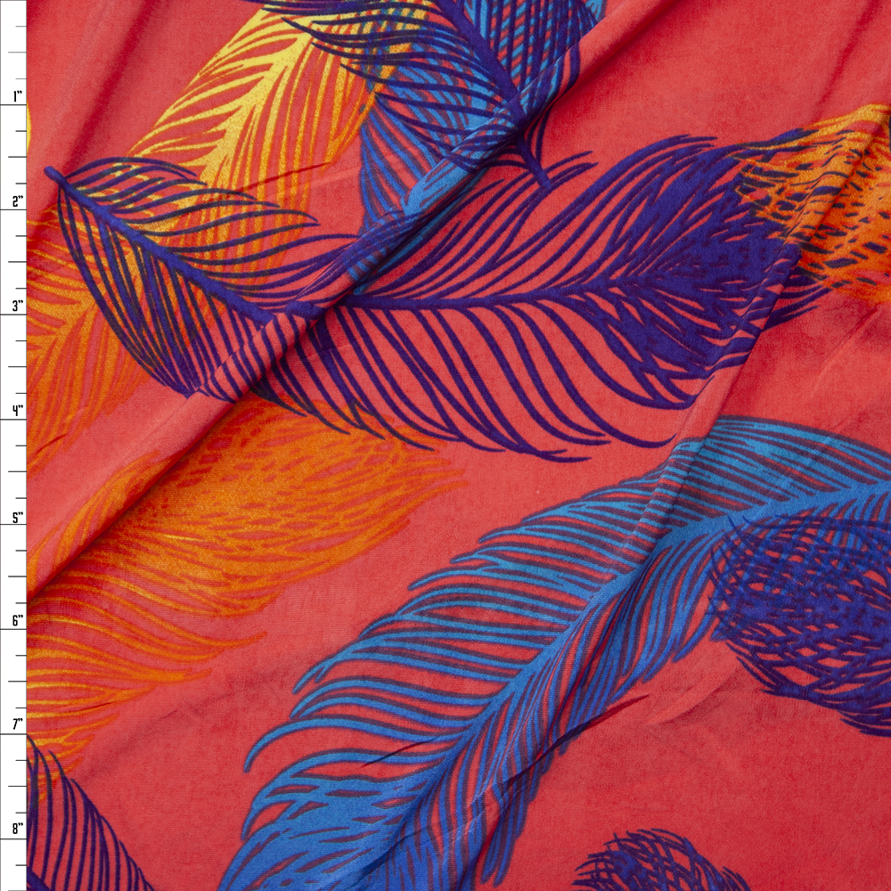 Turquoise, Blue, and Yellow Feathers on Neon Coral Poly/Spandex Knit Fabric By The Yard