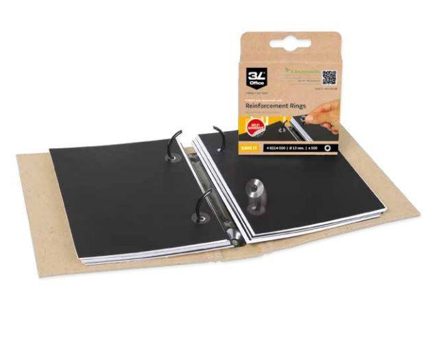 CW Office ValueX Vinyl Reinforcement Rings Pk1000, pack of 1000 black reinforcement rings with a binder punch on a brown cutting mat