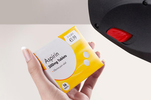 CW Office Avery Labels for Labelling Gun 1-Line Removable White 12x26mm 1500 per Roll (Pack 10) - PLR1226, close-up of a roll of white adhesive labels being used for product labelling in an office setting.