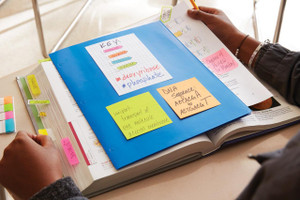 Post-it Notes 38x51mm 100 Sheets Energetic Colours (Pack 12), brightly colored sticky notes on a notebook for study or office organization.