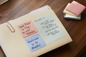 Post-it Recycled Notes, assorted colors on notepad with handwritten notes, on wooden desk