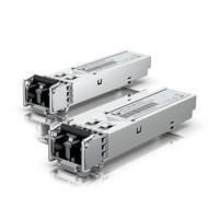 Various Ubiquiti UACC-OM-MM-1G-D-2 (2-Pack) 1G Multi-Mode Optical SFP Module, two SFP modules with compact design and metal casing for optical fiber network connectivity.