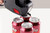 CW Office Avery Labels for Labelling Gun 1-Line Permanent White 12x26mm 1500 Per Roll (Pack 10) - PLP1226, labels being applied to soda cans with a labelling gun.
