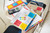 Post-it Post it Super Sticky Notes Playful Colours 76x76mm 90 Sheets (Pack 6), colorful sticky notes on a school or office desk for organization and reminders.