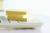 Post-it Recycled Notes 76 mm x 127 mm Canary Yellow (Pack 16), image showing a stack of yellow sticky notes on top of patterned notebooks.