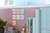 Post-it Post it Super Sticky Notes Soulful Colours 76x76mm 90 Sheets, Pack 6, in various pastel colors attached to a brown office desk partition.