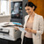 Brother MFC-J5955DW A4 Colour Inkjet MFP, a woman smiling and looking at a brochure in an office setting.