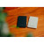 Various Verbatim Charge 'n' Go Essentials MagSafe Power Bank Wireless 5000mAh Black, image showing two compact portable power banks in black and white color on a wooden surface.