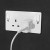 Various LINDY 73415 18W USB Type A Charger, plugged into a power outlet with a charging cable connected.