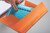 CW Office Oxford Internat PP Wb Meeting Book A4, a black spiral-bound notebook with lined pages and orange cover.