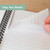 CW Office Cambridge Jotter Notebook A5 200 Pages Pack of 3, close-up of a person turning a page in the white lined notepad, spiral-bound notebook with lined pages for writing and note-taking.