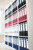 CW Office Leitz 180 Lach File 80MM A4 BLK PK10, organized office filing storage with multiple colored binders on a white shelving unit.