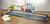 CW Office Avery Precision Trimmer 20-Sheet Capacity Cap A0, cutting paper on a wooden desk in an office setting.