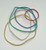 CW Office Q-Connect Rubber Bands 15GM AST Col, a set of colorful rubber bands in red, blue, green, white, and yellow on a plain white background.