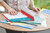 CW Office Elba Report File A4 Red PK50, open report file with transparent cover and multiple colored report files inside on wooden table.
