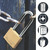 CW Office Master Lock 40MM Brass Padlock 2KEYS, image showing a brass padlock securing a rusted chain on a wooden door.