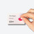CW Office Save Time-Expiring Badge Dots, hand applying a pink expiring badge dot onto a business card.