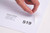 CW Office A4 Integrated Lab S19 160X105 PK1000, sheet labels on a white surface with hand peeling off one label.