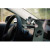 CW Office Verbatim FWC-02 Qi Fast Wireless Car Charger, 360 Degrees Rotatable, Three Mounting Options: Vent Holder, Suction Cup On Dashboard, Or Front Window, smartphone held by the charger inside a car near the dashboard and windshield.