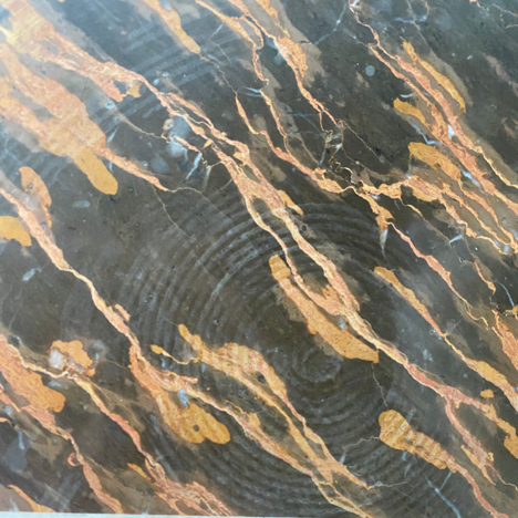 A hot pan left a crisp pattern on Portoro Marble