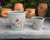 Set of two cream ceramic planters with wildflower and butterfly design.