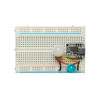 Mini PIR motion sensor connected to a breadboard for prototyping projects.