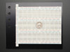 Large solderless breadboard with 2250 points on black plate, close-up top view showing power rail layout. Large solderless breadboard with 2250 points on black plate, close-up top view showing power rail layout.