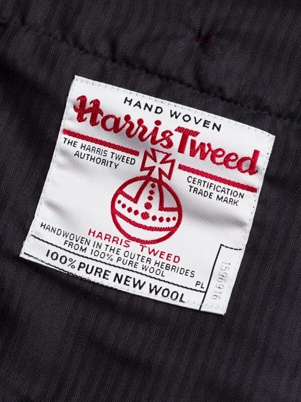 Close Up of Purple Burdock Harris Tweed Trousers Orb Logo
