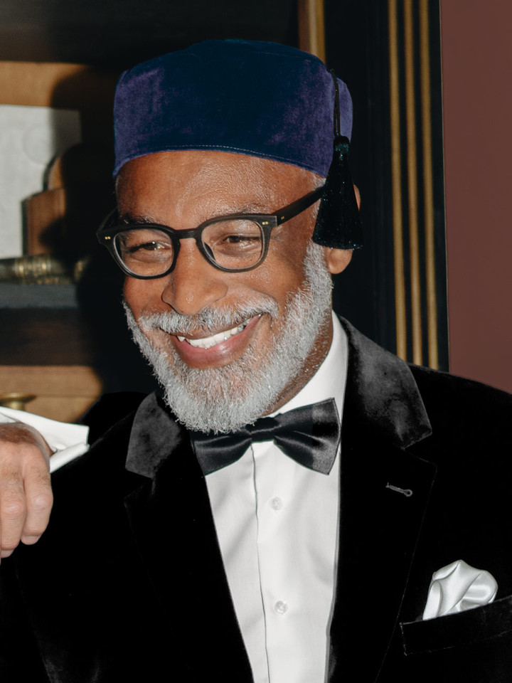 Model wears Men's Navy Blue Velvet Tasselled Smoking Cap