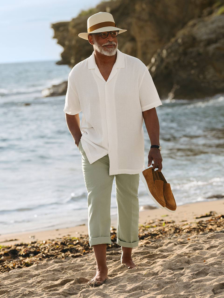 Model holds Men's Tan Tuscany Suede Loake Loafers