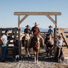 Riding through a wooden round pen gate