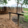 Horse hitching post outside of wooden round pen