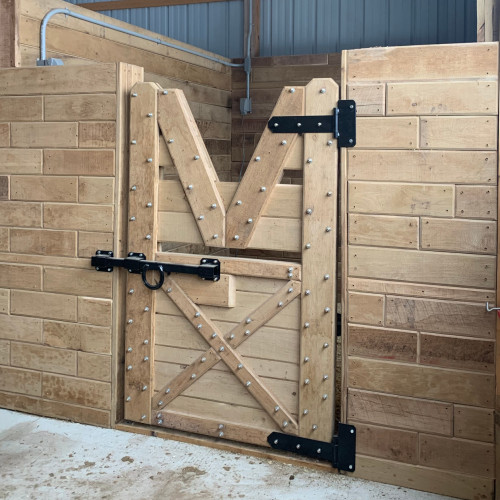 Wooden horse stall door attached to wooden horse stall