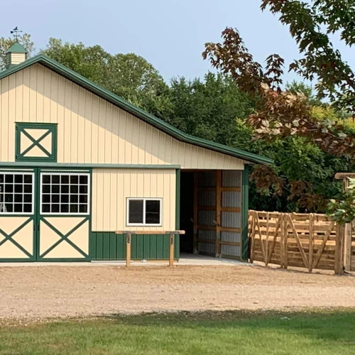 horse barn with a hitching rail out front