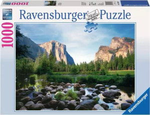 A puzzle featuring the company title "Ravensburger" at the top of the white-bordered cover. In smaller, pink font on the side is the number '1000'. The middle of the box features a photograph from Yosemite Valley with a river in the foreground studded with water-worn rocks. Across the calm waters is a line of trees, and beyond that are the peaks of well worn mountains. A puzzle featuring the company title "Ravensburger" at the top of the white-bordered cover. In smaller, pink font on the side is the number '1000'. The middle of the box features a photograph from Yosemite Valley with a river in the foreground studded with water-worn rocks. Across the calm waters is a line of trees, and beyond that are the peaks of well worn mountains.