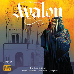 A board game titled "The Resistance: Avalon - Big Box Edition." The word 'Avalon' is the most prominent, written in a bold, white gothic font to match the period the game is set in. The colors of the background wash like a rising sun over the scene, from blazing oranges and yellows at the top to sleepy blues at the bottom. The light strikes over a flat background of a medieval city that fades like an afterthought to contrast the detail of a man that stands in the foreground. The man has a long beard that obscures most of his features and wears a blue hooded cloak detailed with golden Celtic knotwork. He holds a large walking stick close, leaning heavily on it as he looks pensively into the sunrise. He is drawn in a stark style with lots of textured lines. A board game titled "The Resistance: Avalon - Big Box Edition." The word 'Avalon' is the most prominent, written in a bold, white gothic font to match the period the game is set in. The colors of the background wash like a rising sun over the scene, from blazing oranges and yellows at the top to sleepy blues at the bottom. The light strikes over a flat background of a medieval city that fades like an afterthought to contrast the detail of a man that stands in the foreground. The man has a long beard that obscures most of his features and wears a blue hooded cloak detailed with golden Celtic knotwork. He holds a large walking stick close, leaning heavily on it as he looks pensively into the sunrise. He is drawn in a stark style with lots of textured lines.