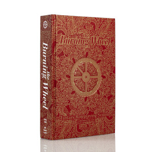 Vibrant red book with the book title and an image of a wheel in ornate gold designs. Vibrant red book with the book title and an image of a wheel in ornate gold designs.