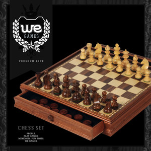 Black box featuring the We Games logo and an ornate wooden chess set with all chess pieces in the opening position. One drawer is open to display the storage space. Black box featuring the We Games logo and an ornate wooden chess set with all chess pieces in the opening position. One drawer is open to display the storage space.