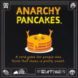A card game titled "Anarchy Pancakes" in orange and yellow font.  The background is black with line details along the borders, and in the center sits a stack of buttery, syrup slathered pancakes with two shiny black eyes and little arms extended up in little rock devil's horns.  A pleased smile graces their little pancake face.