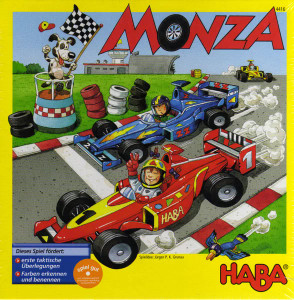 Board game box featuring game title and two racers in cars on a track with a field and a dog waving a checkered flag in the background. Board game box featuring game title and two racers in cars on a track with a field and a dog waving a checkered flag in the background.