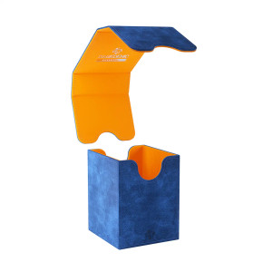 A TCG Deck Box with the company logo "Gamegenic" on the top. The box is blue on the outside and has a jean-like texture to the cloth exterior. The lid is opened to reveal an orange interior. A TCG Deck Box with the company logo "Gamegenic" on the top. The box is blue on the outside and has a jean-like texture to the cloth exterior. The lid is opened to reveal an orange interior.