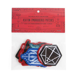 A package of 8 patches inspired by Ashton Greymoore from Critical Role.  The top of the plastic bag that holds them is covered in a red cardboard strip that says "Bells Hells Collection: Ashton Greymoore Embroidered Patches" in black font, and the patches are displayed in clear plastic.  The most visible patch is a sword in a simplified d20, and behind it are patches in blue, black, and red.